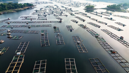 Aerial view of Jatiluhur reservoir with floating house. Scenic view of lake and mountains against...