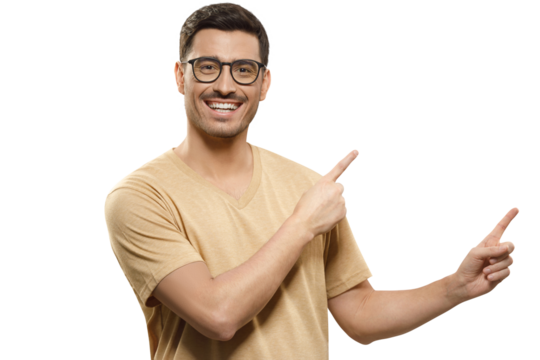 Young  smiling man in beige t-shirt, pointing with index fingers of both hands to beneficial commercial offer