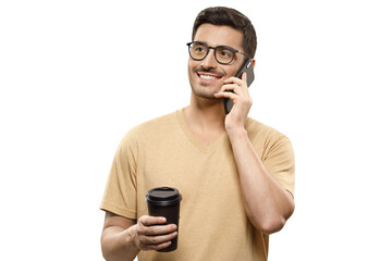 Young man in beige t-shirt and glasses, talking on the phone with positive smile, holding takeaway...