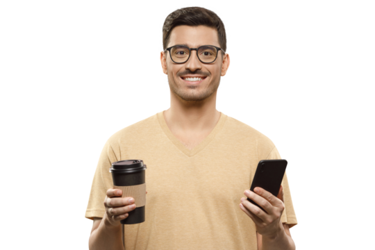 Young man in glasses and beige t-shirt holding coffee cup in one hand and phone in another