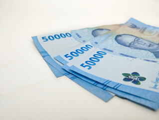 Close up Fifty thousand Indonesian banknotes (Rupiah). Cash payment concept. Indonesian rupiah currency (Rp. 50,000 Fifty Thousand Rupiah) on a white background