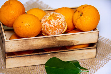 Closeup of tangerines in a wooden case