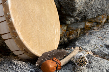 An image of a handmade leather meditation drum with rattle and sacred feather. 