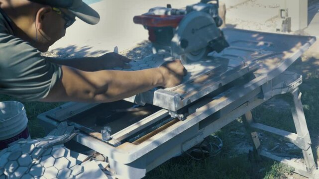 Tiler cutting the tile with a circular saw. The perfect tile-cutting blade for a circular saw when cutting porcelain tile is the diamond blade.