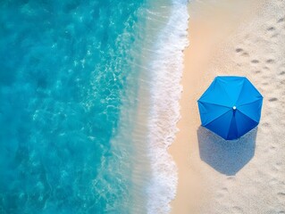 Naklejka premium Aerial View of Vibrant Blue Umbrella on Serene Summer Beach Landscape