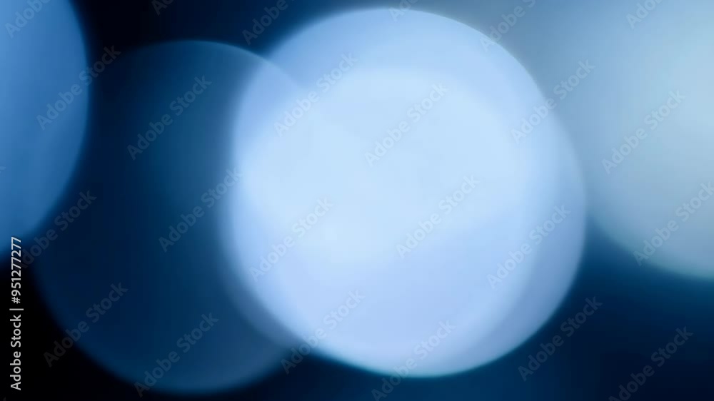 Poster exploring ethereal light patterns and reflections in serene blue tones