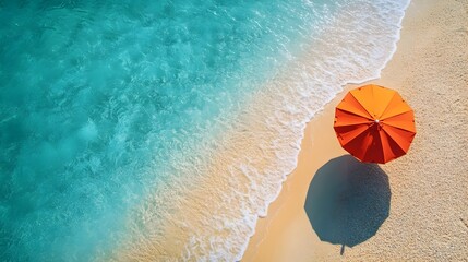 Obraz premium Aerial View of Vibrant Orange Sun Umbrella on Captivating Tropical Beach