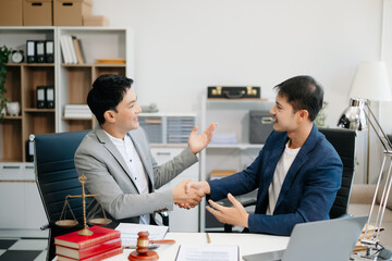 Asian business team and lawyers discussing contract papers sitting at the table. Concepts of law, advice, legal services.