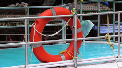 Closeup of a colorful lifeguard safety ring installed in a tourist boat