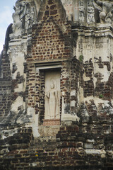 Outdoor Ancient standing stucco Buddha at Main Pagoda ( Prang ) in Wat Ratchaburana ruins is considered a very important temple is Unesco World Heritage Site in Ayutthaya Historical Park in Thailand.