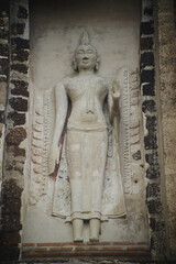 Outdoor Ancient standing stucco Buddha at Main Pagoda ( Prang ) in Wat Ratchaburana ruins is considered a very important temple is Unesco World Heritage Site in Ayutthaya Historical Park in Thailand.