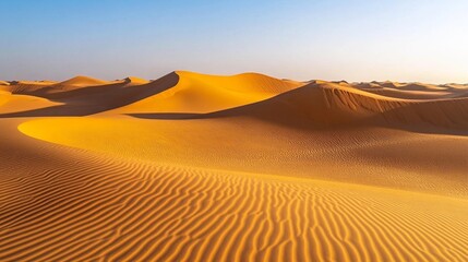 Golden desert dunes under the setting sun with shadows creating stunning patterns in the sand