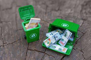 Green Bins Overflowing With Various Currency Notes