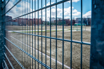 Quiet Sports Ground Seen Through a Fence