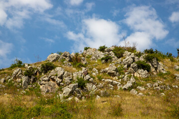 Stones and pieces of rock on top of a hill. A stony hilltop