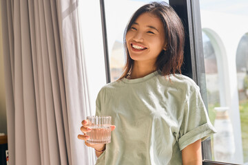 Diet. Woman Drinking Water In A Sunlit Room, Emphasizing Hydration, Wellness, Healthy Lifestyle. Refreshing Morning Routine