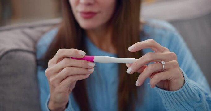 Nervous, pregnancy test and hands of woman waiting for results in living room at apartment. Happy, anxious and female person on sofa with hope for positive prenatal stick for ivf treatment in home.