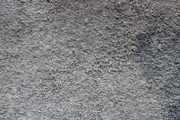 Close-up of a rough, textured grey wall.