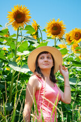 Happy woman in the sunflower field.