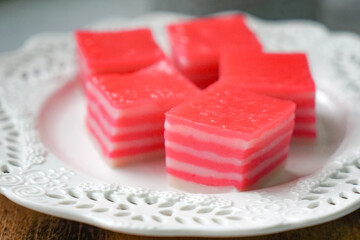 Kuih Lapis, a traditional Malay layered steamed cake and dessert, in white plates.