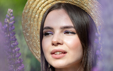 Portrait of a girl wearing a straw hat in lupine colors