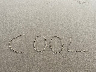 on the beach is carved with letters in the smooth sand the writing cool