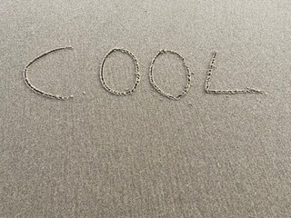 on the beach is carved with letters in the smooth sand the writing cool
