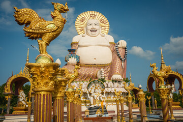 Wat Plai Laem Temple buddhist in Koh Samui Island Thailand tilt up of big buddha sculpture landmark