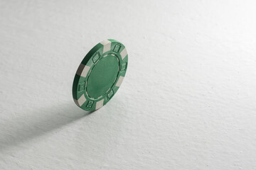 A green isolated poker chip.