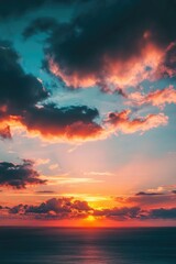Sunset over ocean on cloudy day