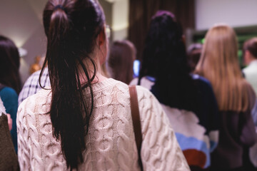 Group of students and school pupils in a science museum exhibition, excursion tour with guide, a docent with a tourist visitors, school field trip, attendees of technical museum exposition gallery