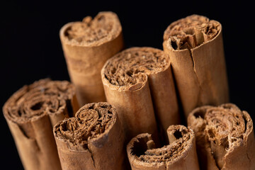 Thick wooden cinnamon on a black slate board