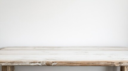 Empty wooden white table over white wall background