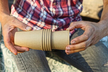 set of paper gray natural empty new for coffee simple without lid clean cups in hands of man dressed in checkered shirt  and jeans daytime on street