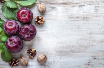 Plums and Walnuts on Rustic White Wooden Background