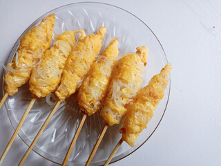 Telor gulung (egg roll), Indonesian street food served on plate on White background.
