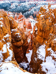 Snow scene colorful cliffs with red rock and stone in Bryce Canyon National Park