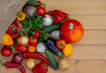 fresh vegetables and paper bag on wooden background. Selective focus
