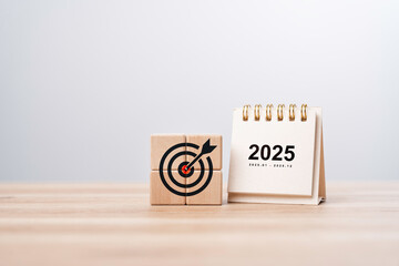 Calendar happy new year 2025 with goal icon on wooden blocks. New year resolution, goal, plan, and...