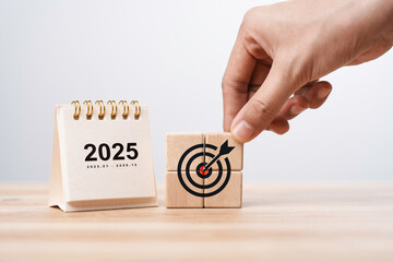 Calendar happy new year 2025 with goal icon on wooden blocks. New year resolution, goal, plan, and...