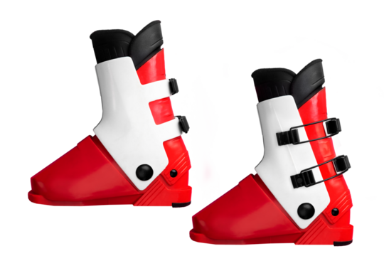 Red and white ski boots with black buckles on isolated background.
