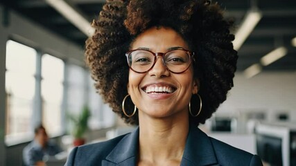 Confident black woman with afro hair smiling in a startup office - Powered by Adobe