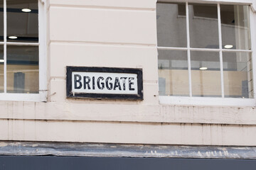 Naklejka premium Leeds England: 3rd June 2024: Briggate Street sign Exterior sign no people in Leeds city centre