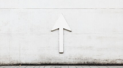 Simple minimalist arrow pointing upwards, on a smooth, light grey wall