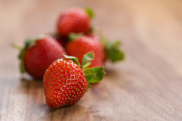 ripe strawberries on wood background with copy space