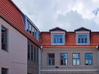 City landscape. Renovated building facade. Restored old house with tiled roof. Restoration of historical buildings. Kuldiga, Latvia.