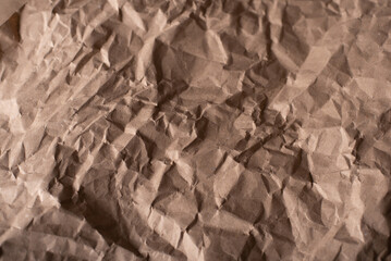Background of crumpled brown paper. Paper from fallen leaves. Textured background from paper