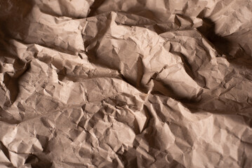 Background of crumpled brown paper. Paper from fallen leaves. Textured background from paper
