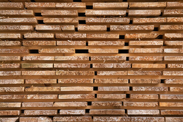 Studs in a lumber yard featuring the wood grain, stacked block board