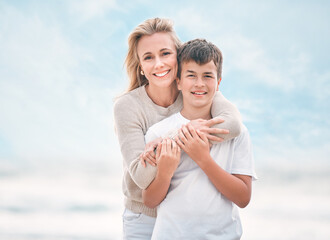 Portrait, support and mother with son on beach together for holiday, travel or vacation. Hug, love or smile with single parent woman and boy child embracing outdoor for bonding or wellness in summer